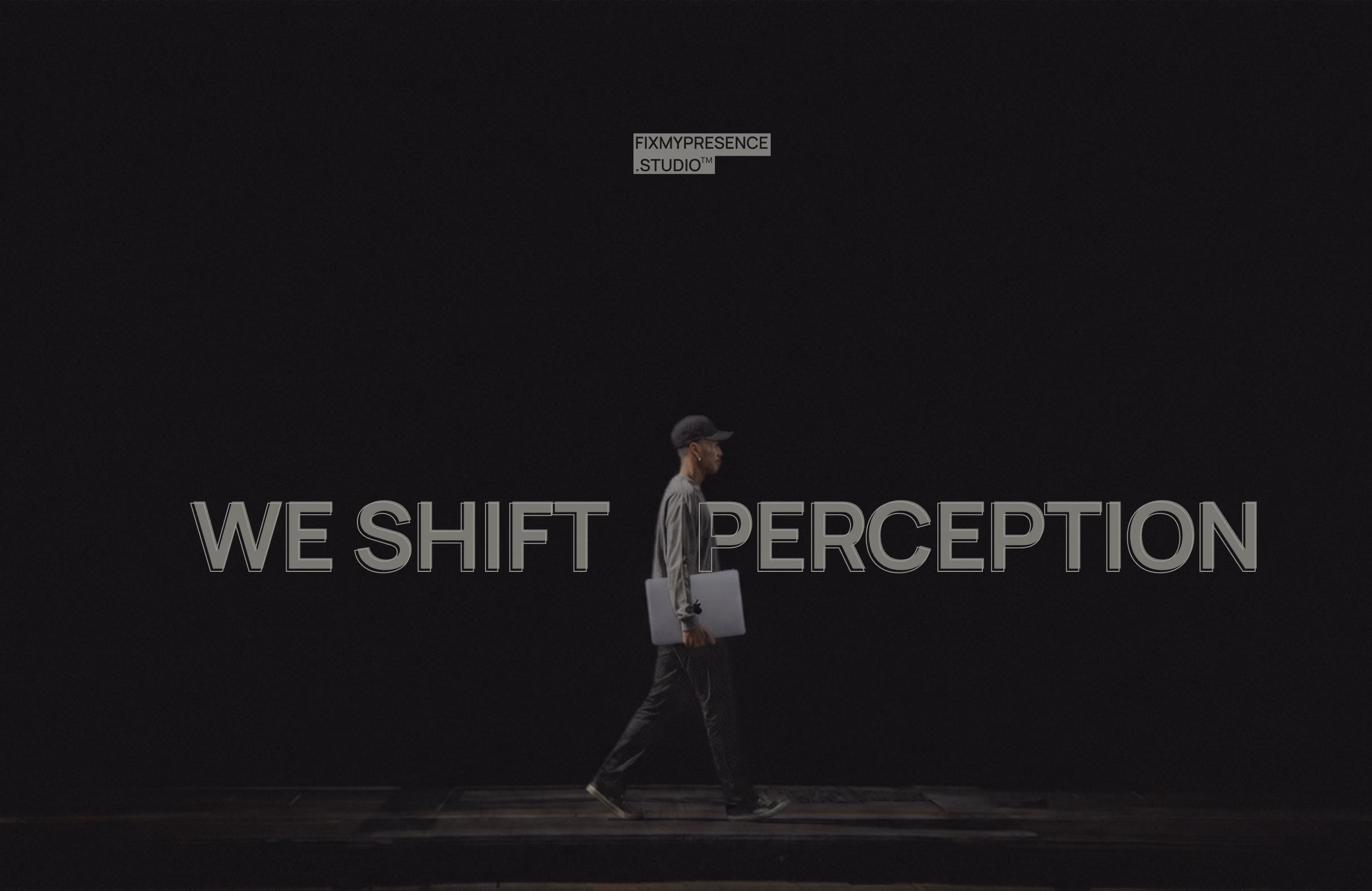 A person walking in front of the words WE SHIFT PERCEPTION.